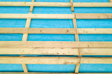 Top down detail of a wooden roof frame on a house under construction.