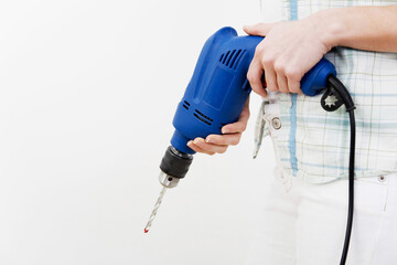 A woman holding power drill