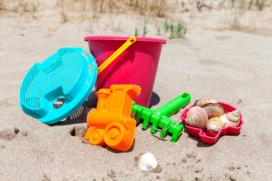 Toys for little kids on the beach on sunny day