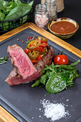 Sliced steak with fresh herbs and vegetables