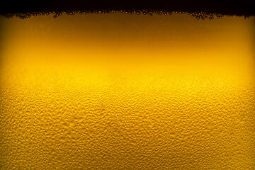 Close up of glass of cold beer with dew and condensate water droplets on the surface of the glass