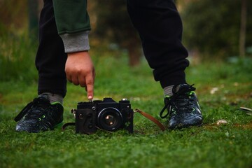 A vintage camera with a kid playing with it 