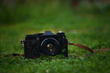 A vintage camera with a kid playing with it 