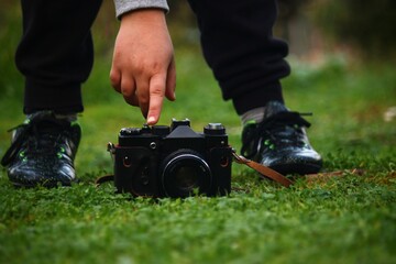 A vintage camera with a kid playing with it 