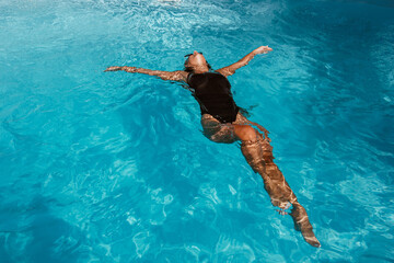 Woman relaxing by the pool