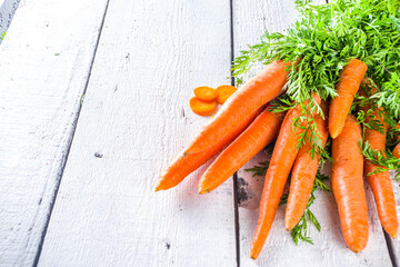 Healthy detox orange carrot smoothie or juice in mason jar on white  wooden background with fresh carrot bunch. Vegan vegetable smoothie.