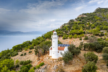 Naklejka premium Gelidonya Lighthouse at cape in Mediterranean sea. Lighthouse and three Islands on Lycian Way in. Karaoz, Antalya, TURKEY