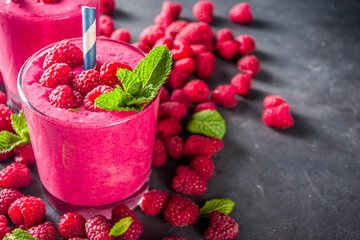 Summer sweet diet appetizer. Raspberry fruit smoothie, milk shake in glass jars, top view. Berry healthy yogurt cocktail with fresh raspberries on dark grey background