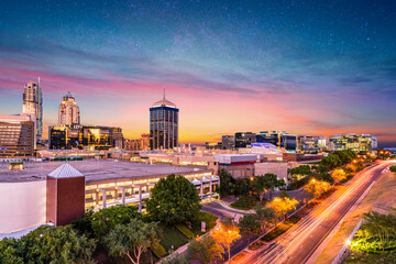 Fototapeta premium Sandton City at night with city lights and stars in the sky