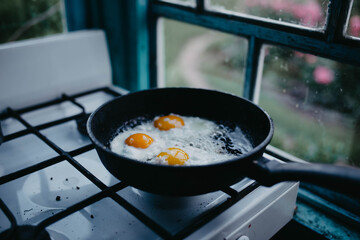 frying eggs in a pan in the village