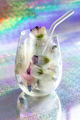 Ice cubes with flowers in glass