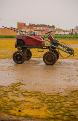 Old small tractor in the field to plow the land