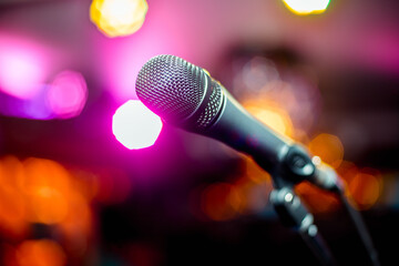close-up stage microphone with blurry lights in the background