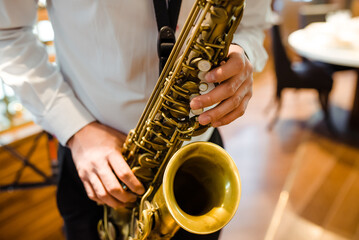 Obraz premium A man plays the saxophone. close-up of hands