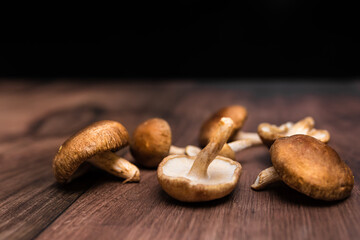Close-up british mushrooms on a wooden brown table with free space for your decoration/text.