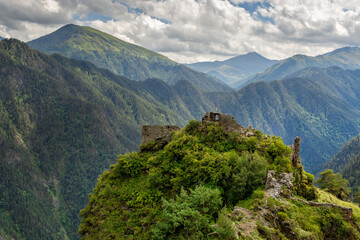 Ruins of an old stone fortress of an abandoned mountain village. Against the background of mountain...