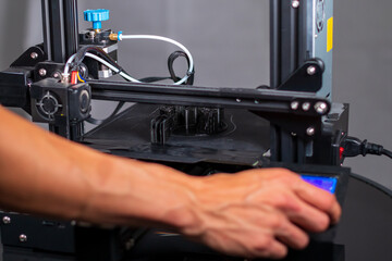 3D plastic printer during work in a factory three dimensional printing. Close-up detail.