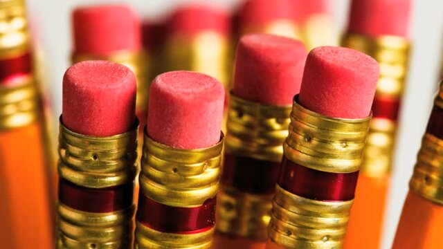 Close up of a bundle of lead pencils showing erasers