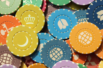 Lot multicolor assorted gambling playing chips surface. Colorful casino chips background. Many...