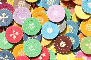 Lot multicolor assorted gambling playing chips surface. Colorful casino chips background. Many...