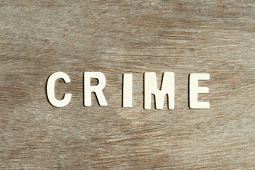 Alphabet letter in word crime on wood background