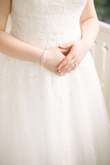 The bride is wearing a bracelet and a ring.