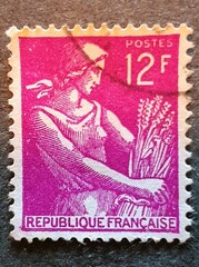 old french stamp with the image of a woman with ears of wheat