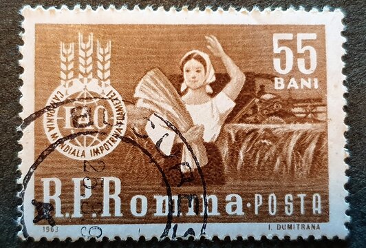 old Romanian stamp from 1969 with the image of a peasant with wheat ears