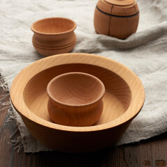 empty round brown plate standing on a gray linen napkin