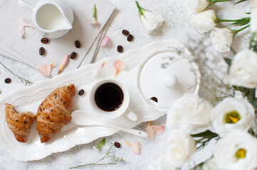 Romantic breakfast tray with coffee cup and croissant