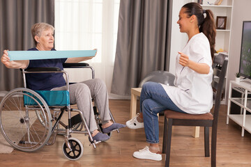 Doctor doing rehab with senior woman in wheelchair. Training, sport, recovery and lifting, old...