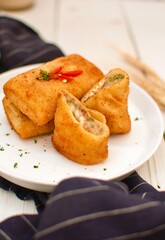 Fried Risoles or Risol Mayo is a typical Indonesian traditional street food made from flour skin, meat and vegetables stuffing inside with mayonnaise and chili sauce. Popular during fasting in Ramadan