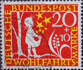 GERMANY - CIRCA 1959: a postage stamp printed in Germany showing Motifs from the fairytale Stern thaler by the Brothers Grimm as a silhouette