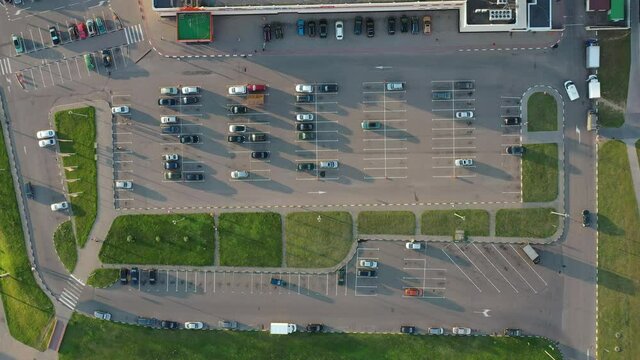 Parking in the city near the shopping center at sunset in summer. view from above. aerial photography
