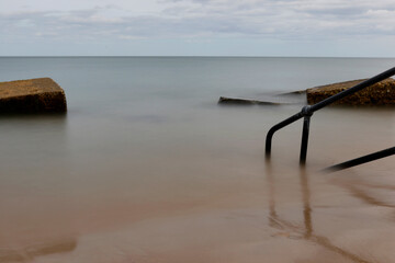 Long exposure of railings in the sea