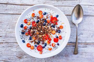 A bowl of delicious yogurt with grains and fresh berry fruit. Weight loss and healthy diet.