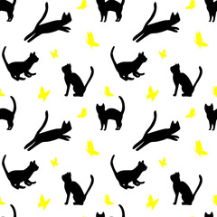 Black cat catching yellow butterfly
