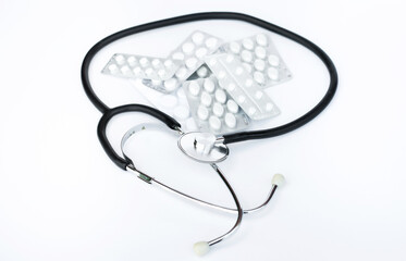 stethoscope and pills on a white background. Treatment concept
