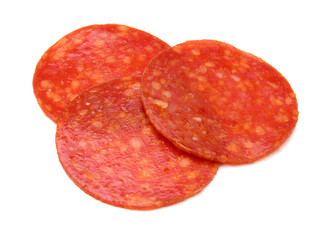 Slices of pepperoni on white background 