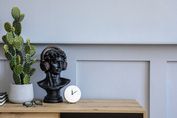 Modern scandinavian home interior with design wooden commode, copy space, books, cacti, clock,...