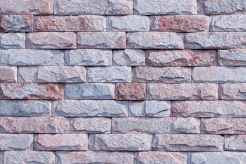 Light gray brick wall made of natural stone