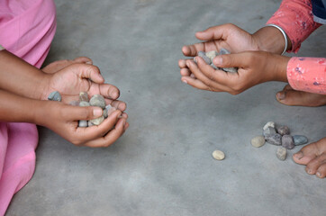 hold the many  small  stone in hands male female.