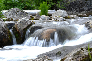 mountain river was shot with a slow shutter speed to capture its movement and the passage of time