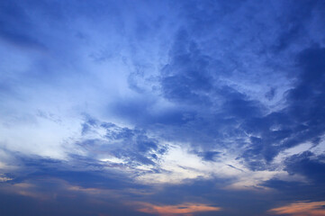 Naklejka na ściany i meble Abstract blue-orange clouds at sunset sky background. Panorama style background