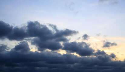 Naklejka na ściany i meble Dark clouds before rain on blue sky background