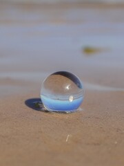Fototapeta na wymiar Sunny day at the beach through a ball lens. Sea and sand beach, shell
