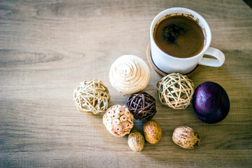 Cup of black coffee on wood background. Traditional strong Turkish coffee. Morning drink. Close-up of black coffee on wooden table.