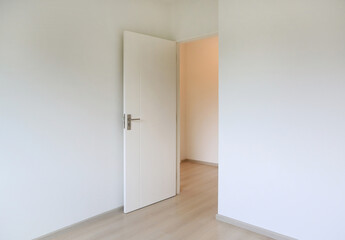 Open door in the white room of new house
