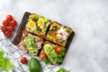 Assortment of vegan sandwiches with avocado and tomatoes