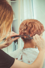 Fototapeta premium Woman brushing her hair